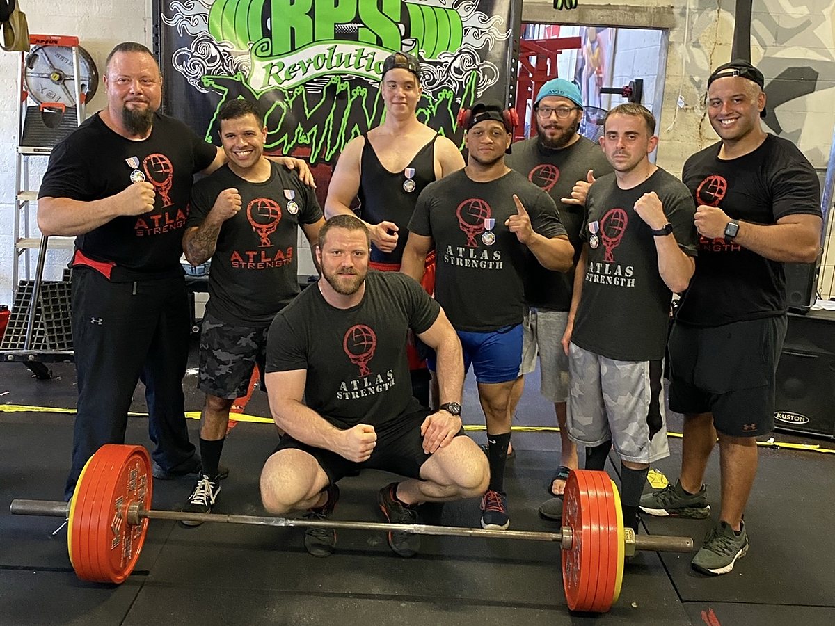 Atlas Strength powerlifting team with medals at a meet