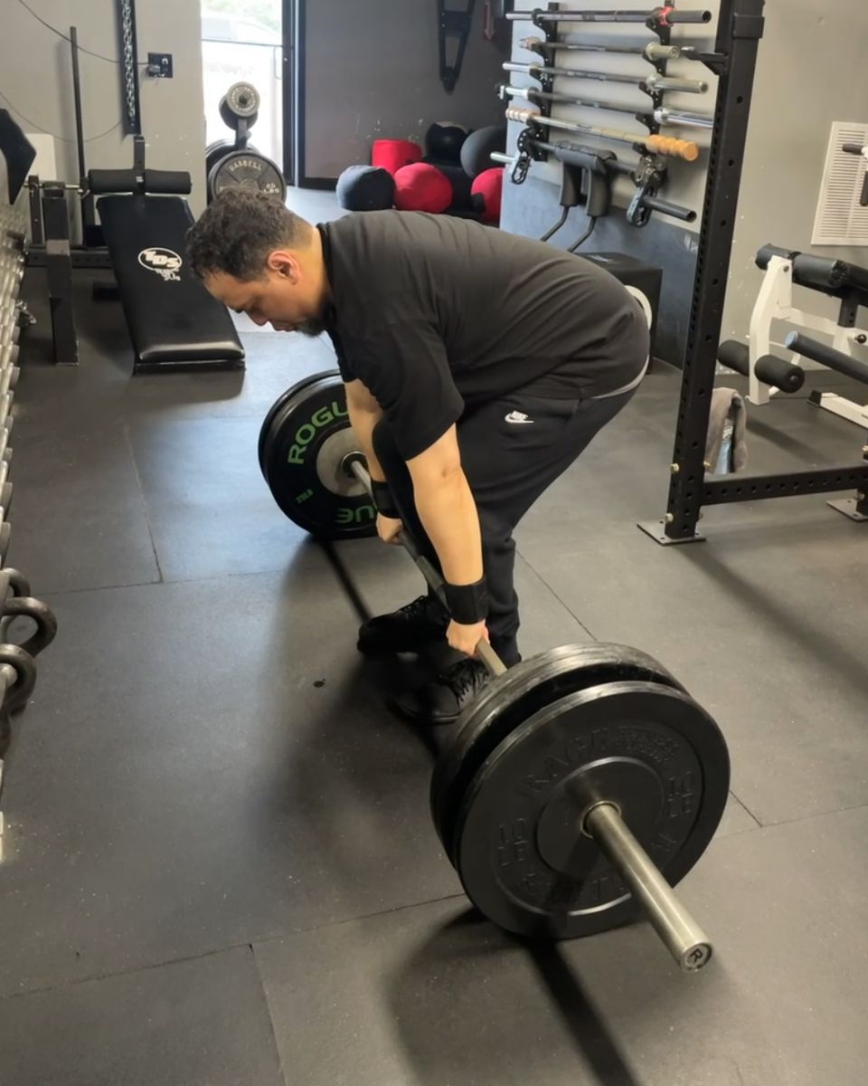 Client setting up for a deadlift at Atlas Strength