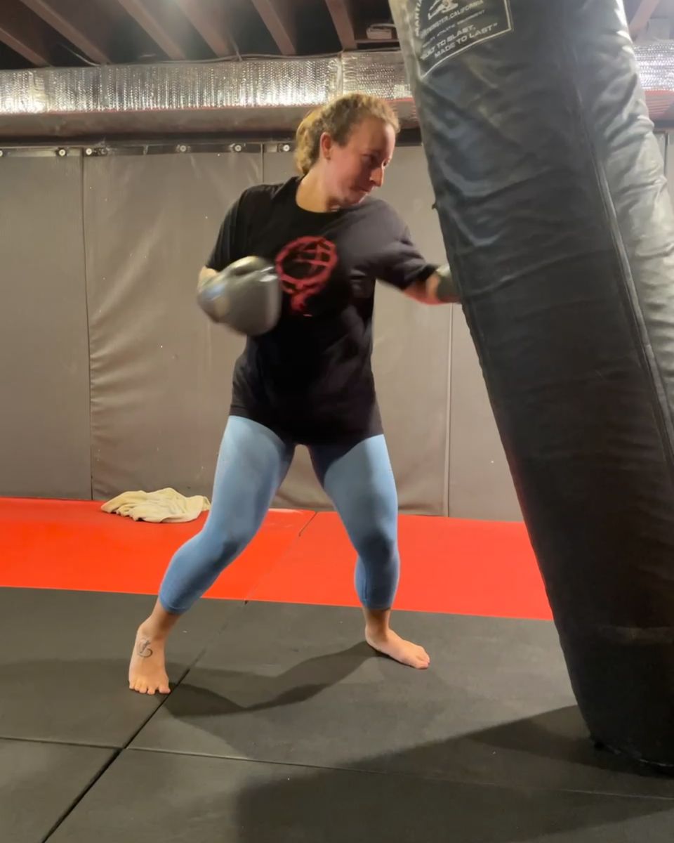 Client punching the heavy bag at Atlas Strength