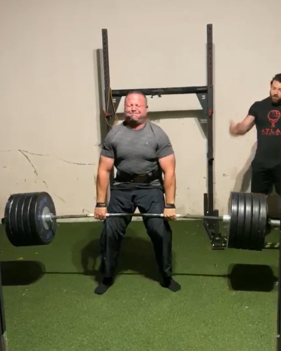 Patrick Rice coaching an older lifter through a heavy deadlift