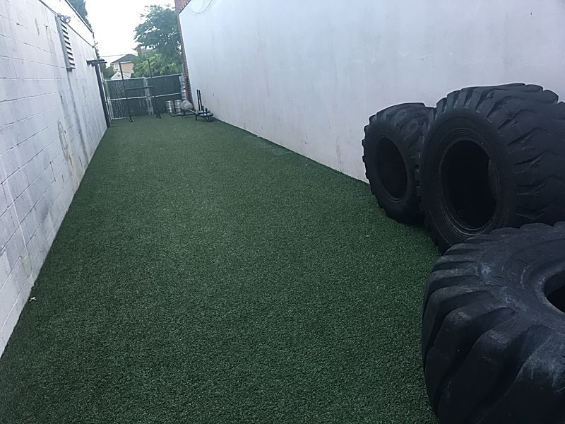 Outdoor turf with tires, sleds and kegs
