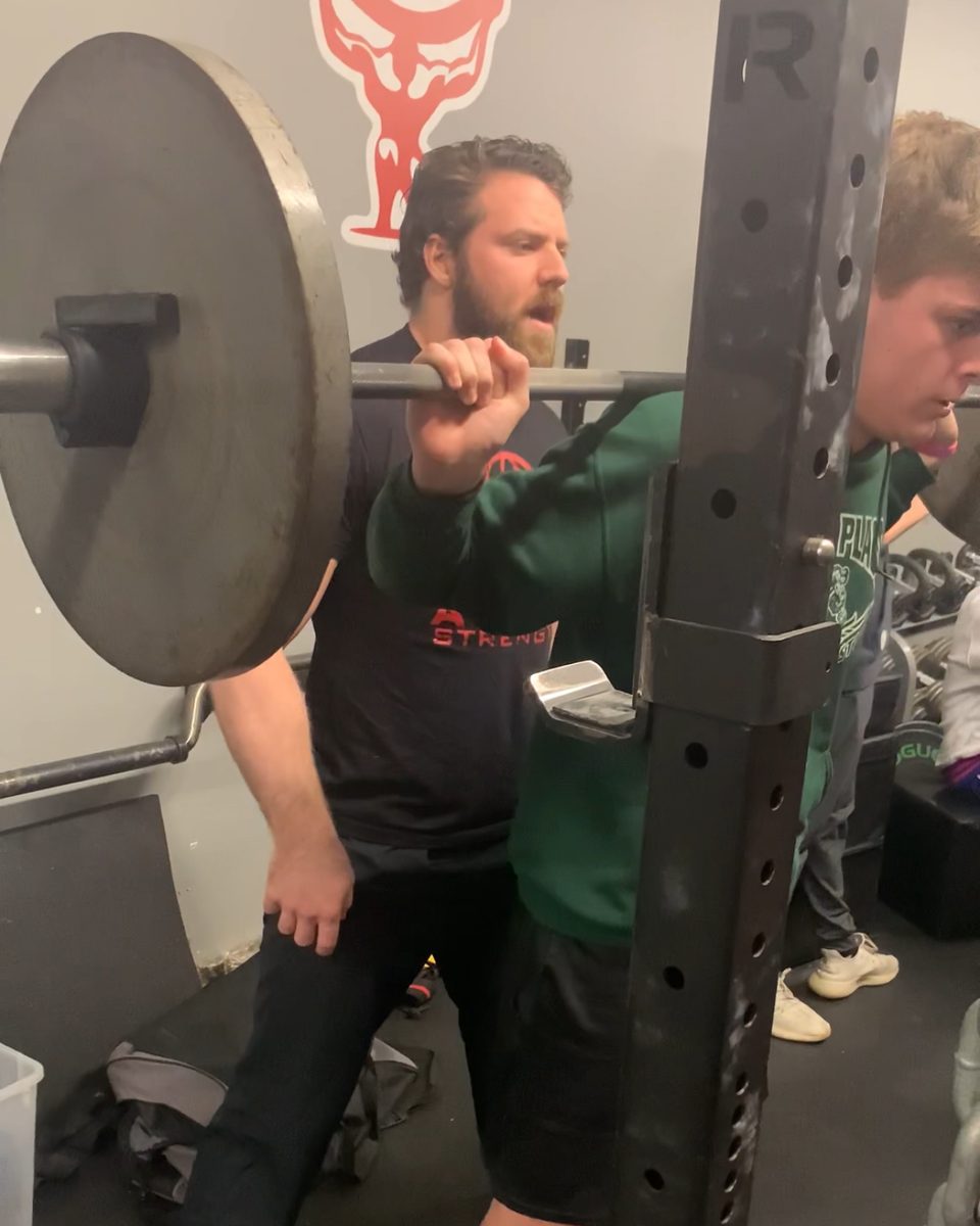 Patrick Rice coaching a squat