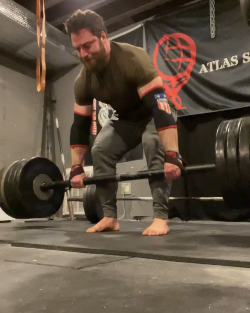 Patrick Rice deadlifting under the Atlas Strength banner