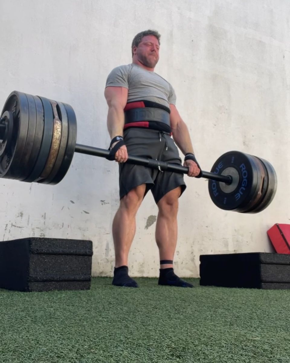 Patrick Rice locking out a heavy deadlift on the turf