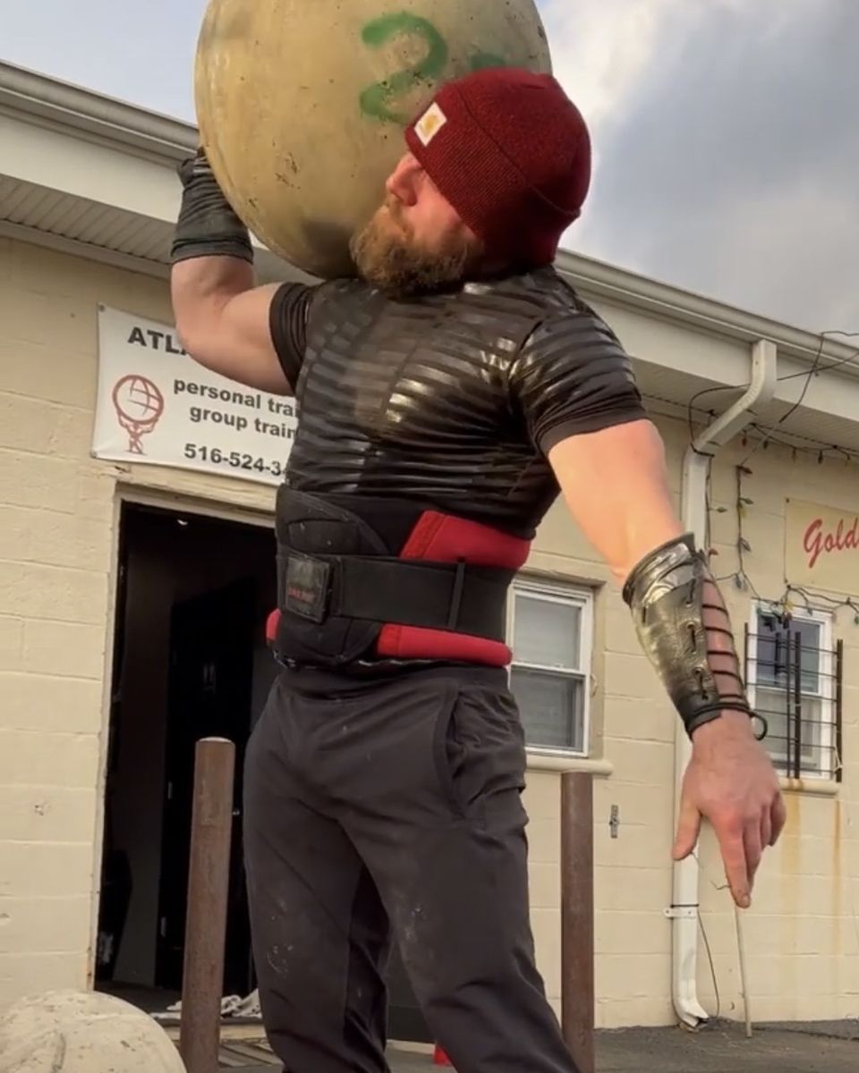 Patrick Rice loading an Atlas stone outside Atlas Strength in Carle Place