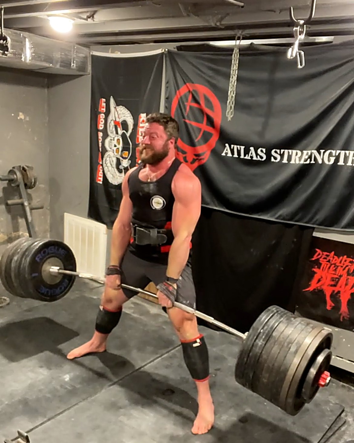 Patrick Rice pulling a heavy sumo deadlift under the Atlas Strength banner