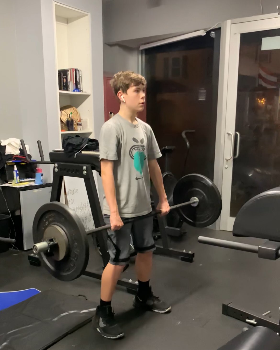 Teen locking out a deadlift at Atlas Strength