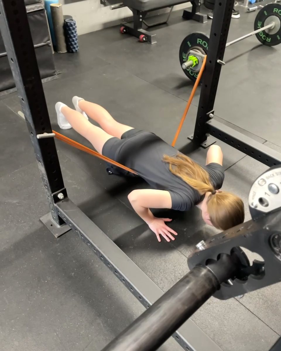 Client doing a band-assisted push-up