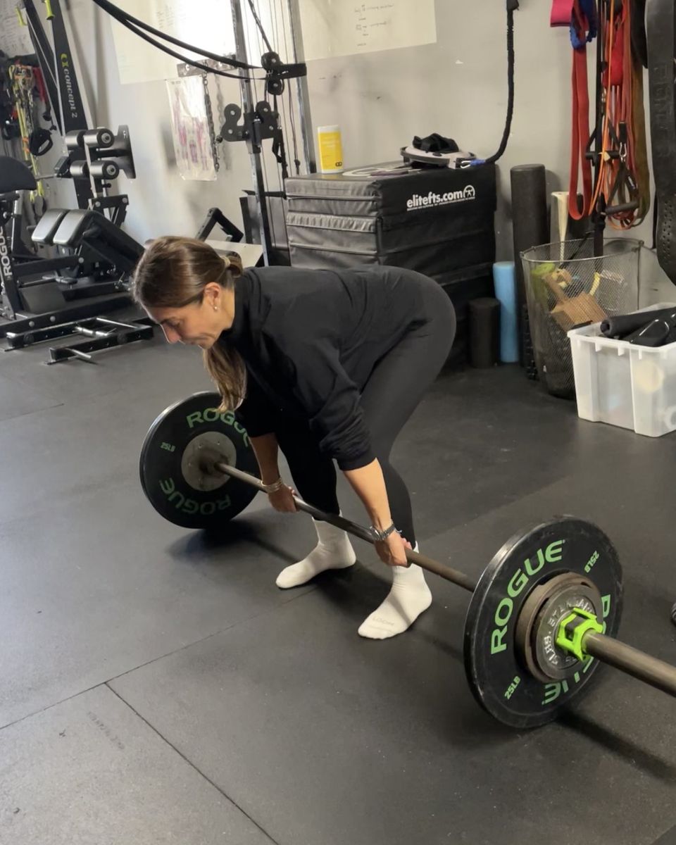 Woman setting up for a deadlift at Atlas Strength