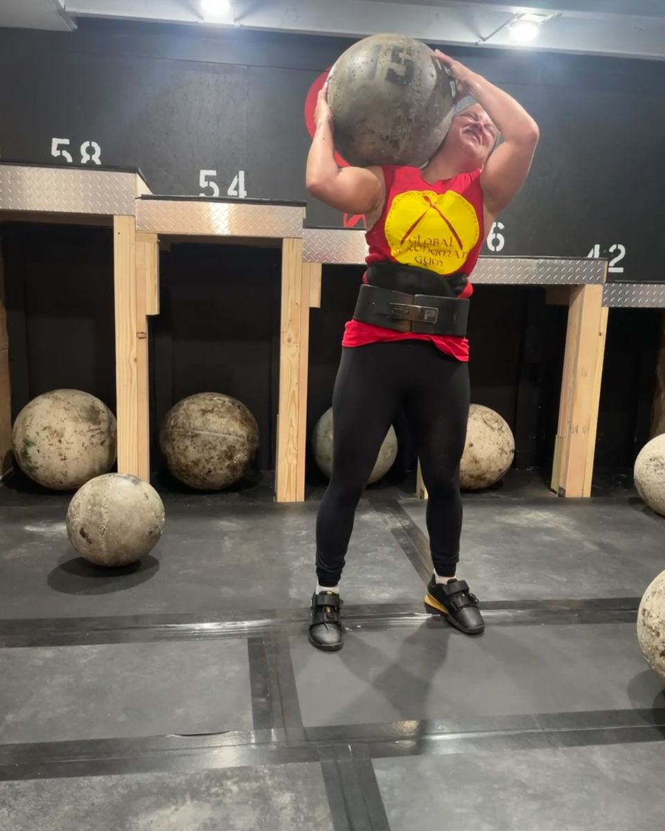 Woman loading an Atlas stone at Atlas Strength