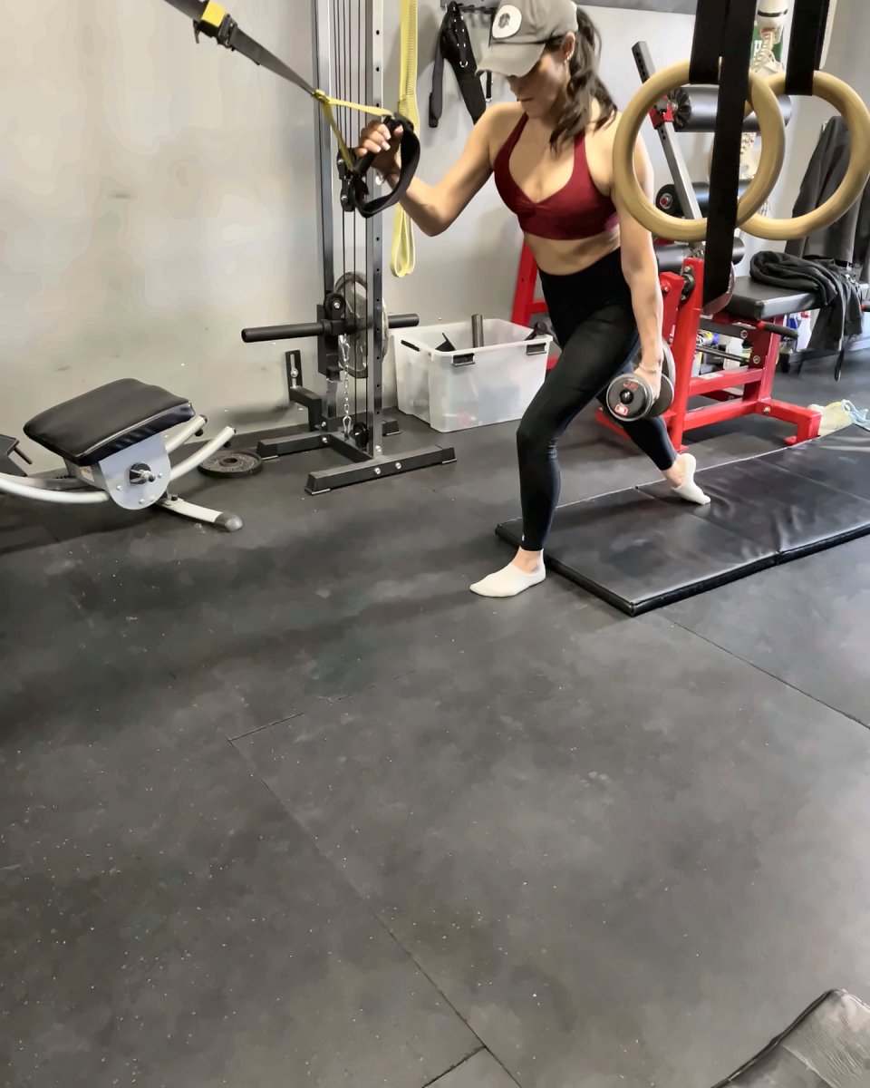 Woman doing a split squat with a cable row