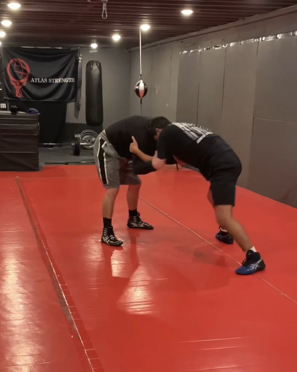 Wrestlers hand fighting on the mats at Atlas Strength